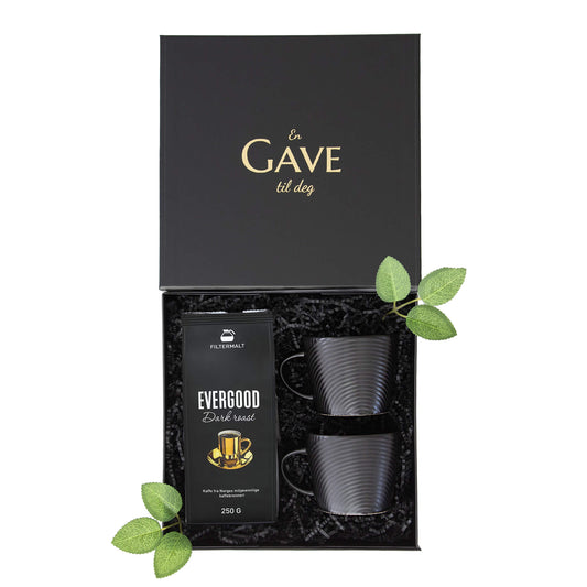 Gave til han eller henne med kaffe og svarte kopper. Alt i en elegant åpen svart gaveeske.