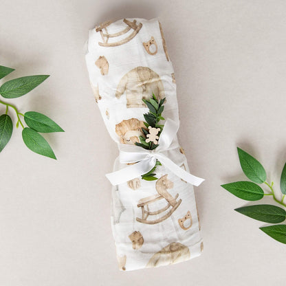 Eksklusivt babypledd med en hvit sløyfe.