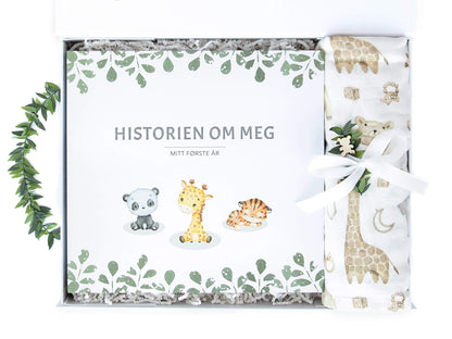 Gaveeske med babyjournalen "En historie om meg" som tar for seg den nyfødtes første år og et musslinteppe i bomull og bambus stoff.