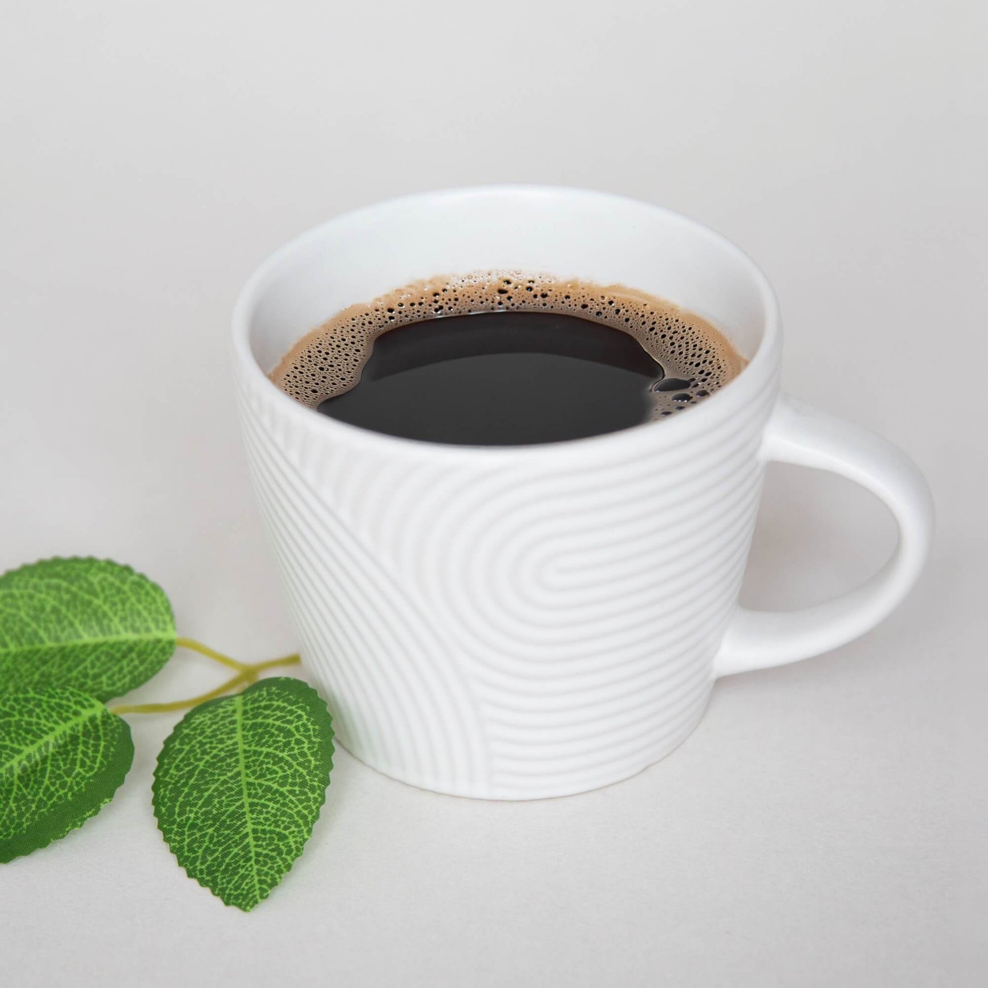 Håndlaget keramikkopp med kaffe.